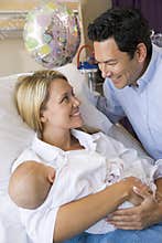 New mother with baby and husband in hospital