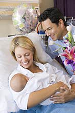 New mother with baby and husband in hospital