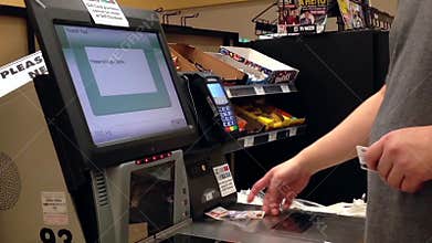Man taking receipt after paying for food at self checkout counter
