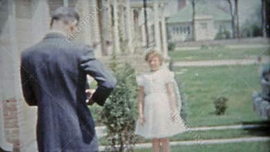 HOUSTON, TEXAS 1953: Girl celebrating her first catholic communion kissing grandma.