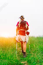 Woman hiker meadow sun