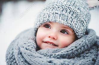 Close up winter portrait of adorable smiling baby girl