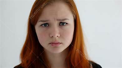 Unhappy sad teenage girl isolated at white background
