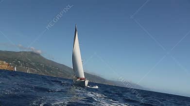 Sailing ship yachts with white sails in the Sea. Luxury boats.