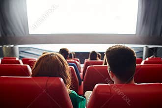 Happy couple watching movie in theater or cinema