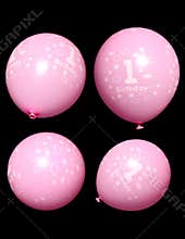 Four pink first birthday balloons