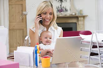 Mother and baby in home office and telephone