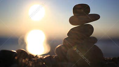 Stones pyramid on beach symbolizing zen, harmony