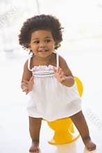 Baby indoors going on potty smiling