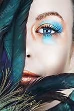Woman with blue and bronze make-up
