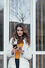 Beautiful girl with a phone in town