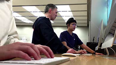 Woman sending message for her friend inside Apple store