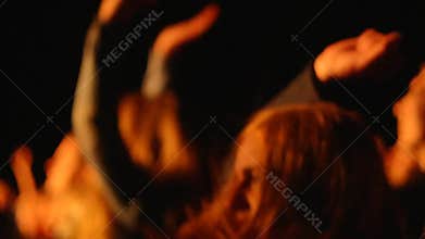 Dancing girl fun on concert hands in air