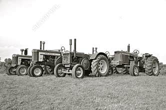 Old two cylinder John Deere tractors(black and white)