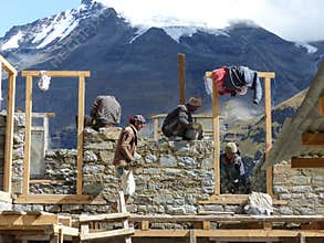 Workers Building a Stone House in Nepal with Himalaya Backdrop