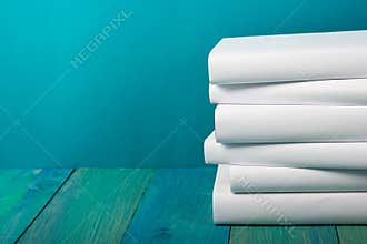 Stack of colorful books, grungy blue background, free copy space