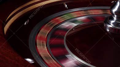 One part of fast running wheel roulette, white ball falls, close up