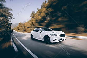 White car speed driving on asphalt road