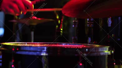 Concert of rock band. Drummer playing on stage