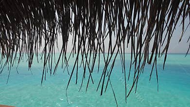 View to bungalow straw shed and sea