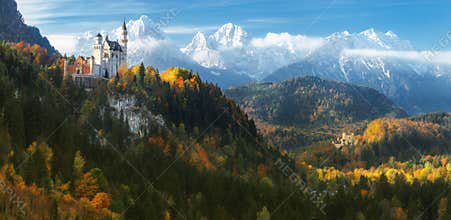 Germany. Panorama. The famous Neuschwanstein Castle and Hohenschwangau Castle on the background of snowy mountains.
