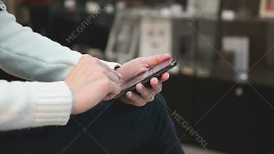 Young girl using a smart phone at the beauty salon