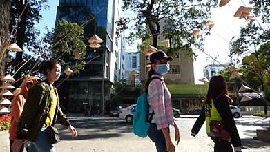 People walk on street in Saigon, Vietnam
