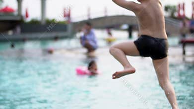 Happy asian child running and jumping in to the pool.Slow motion 120 FPS