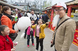 Chinese family has fun with cotton candy emperor beard