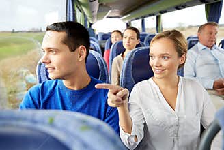 Happy couple or passengers in travel bus