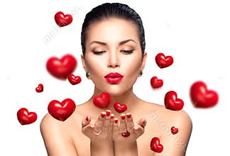 Beauty woman blowing Valentine hearts