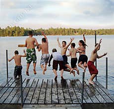 Group of kids jumping into Lake