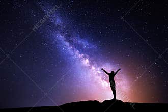 Milky Way. Night sky and silhouette of a standing girl