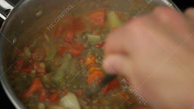 Cooking Lentil Soup with Tomatoes and Vegetables