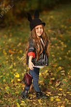Happy little child, baby girl laughing and playing in the autumn on the nature walk outdoors.