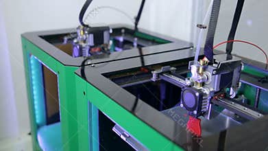 Two 3D printers creating objects.