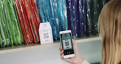Woman shopping scanning qr code with smartphone