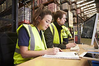 Staff managing warehouse logistics in an on-site office