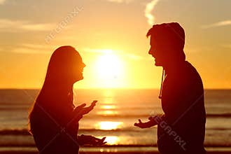 Friends or couple of teens talking happy at sunset