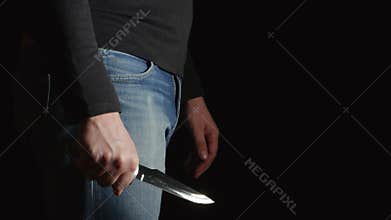 Side view of Danger man with a knife comes in the frame and moves on