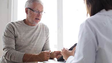 Senior man and doctor with tablet pc at hospital 51