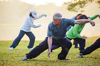 People practice Tai Chi Chuan in a park