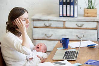 Portrait of young business mom having headache because of crying