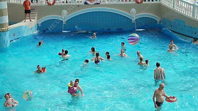 Adults and children resting in waterpark