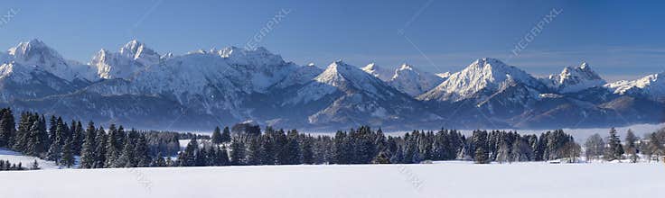 Wide panorama landscape in Bavaria with alps mountains and lake in winter