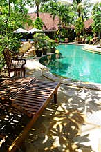 Tropical resort landscaping, pool side chairs