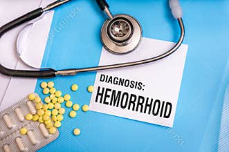 Hemorrhoid word written on medical blue folder