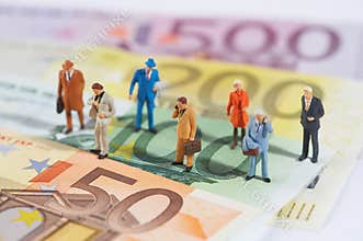 Business people walking on paper money