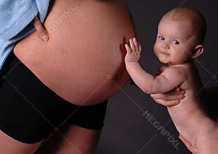 Baby touching pregnant abdomen