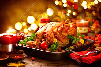 Thanksgiving table served with turkey, decorated with autumn leaves